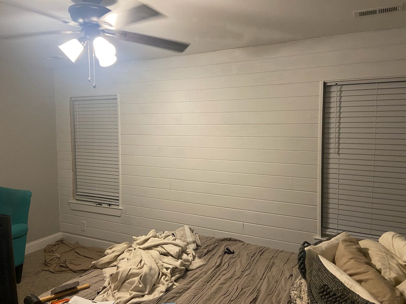 Finished bedroom with light wood paneled walls