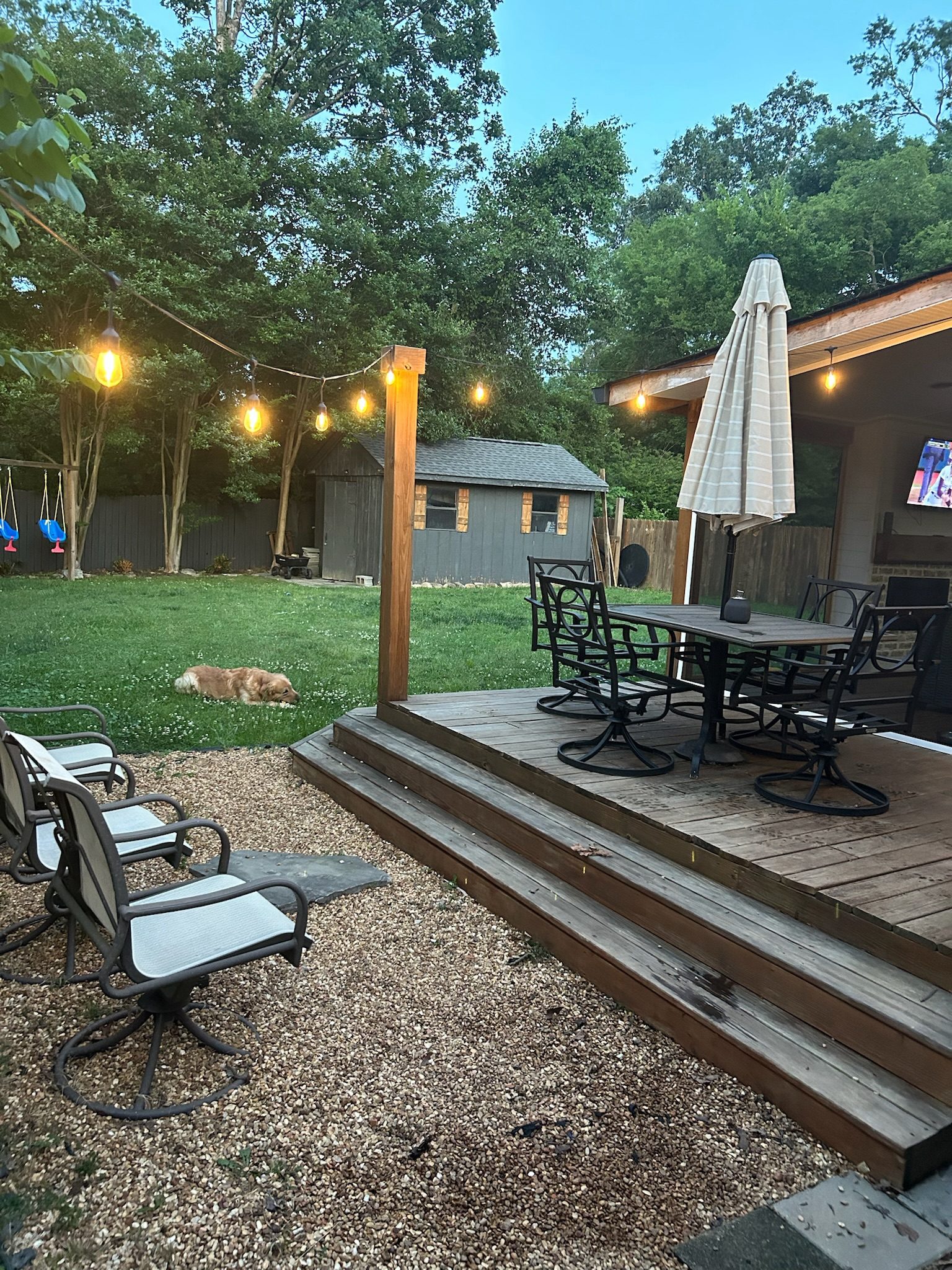 Backyard deck at evening with string lights